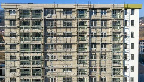 Front view of residential apartment building under construction with scaffo.. Stock Photos