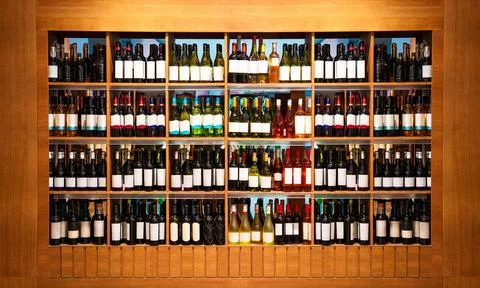 Front view retail display with wine bottles. Wine shop background. Stock Photos
