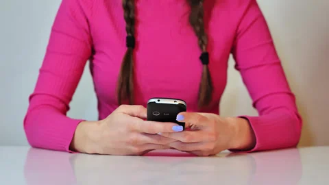 Front View of Retro Phone Interaction With Nostalgic Early Mobile Era Feel Stock Footage 336666092