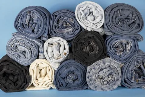 Front view, rolls of jeans. Texture of denim fabric. Stock Photos