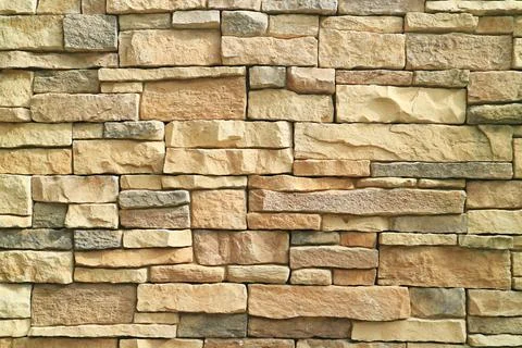 Front View of Rough Stone Blocked Wall in the Sunlight 스톡 사진
