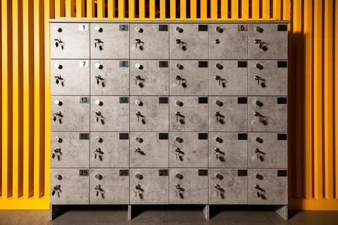 Front view of rows of numbered grey mailbox with keys in modern design build Stock Photos