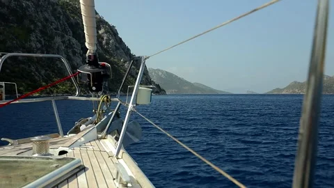 Front view of sailing yacht moving on a sea bay Stock Footage 333311901