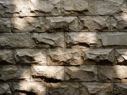 Front view of sandstone wall featuring textured stone block Stock Photos