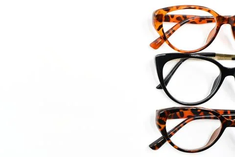 Front view of a selection of pretty women's glasses on a plain background Foto stock