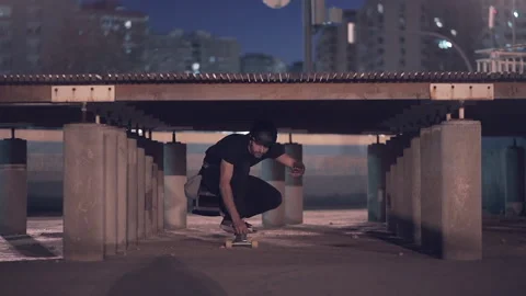 Front view of skater sliding below wood bridge in urban area of the city Video stock 209472685