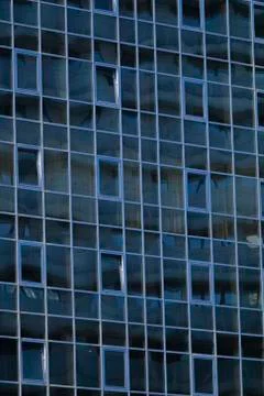 Front view of sky and cloud reflection on modern office building glass wall and Stock Photos