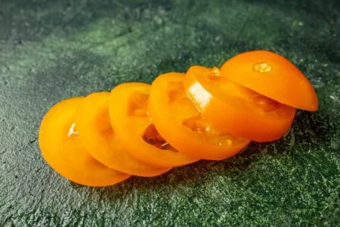 Front view sliced orange tomatoes on dark green background fruit vegetable .. Stock Photos