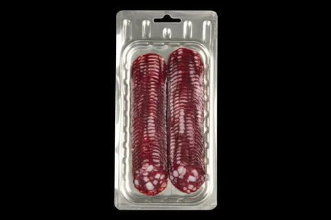 Front view of sliced smoked meat salami in vacuum package isolated on black.. Stock Photos