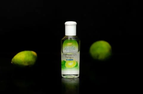 Front view of a small bottle of the Antis Antiseptic isolated in a black back Stock Photos