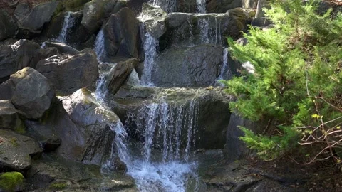 Front view of small waterfall, water surface flows over rocks Stock Footage 152356236