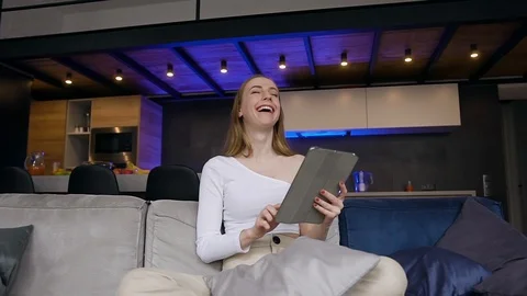 Front view of smiling good-looking satisfied girl in white clothes which sitting Stock Footage 127097409