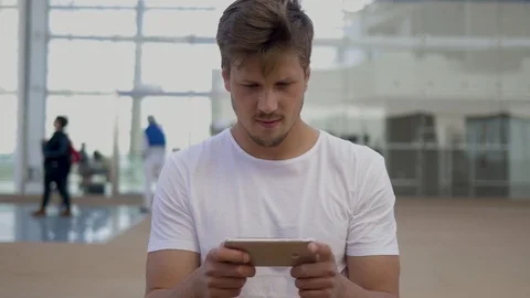 Front view of smiling young man using smartphone. Stock Footage 106679393