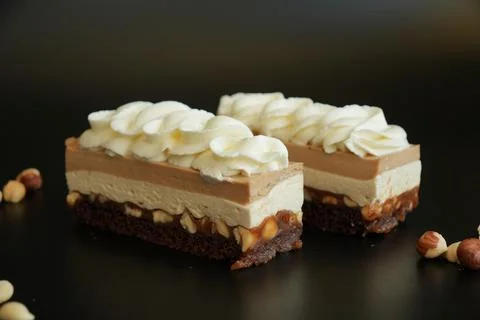 Front View of Snickers Inspired Layered Cake with Caramel, Nougat and Hazelnuts Stock Photos