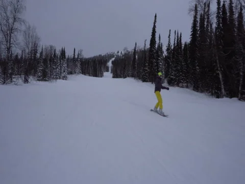 Front view of snowboarder is drifting and making a selfie on snowcovered Stock Footage 71609102