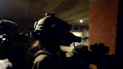 Front view a special forces soldier with a weapon in a fighting stance, a sharp  Stock Footage 301300978