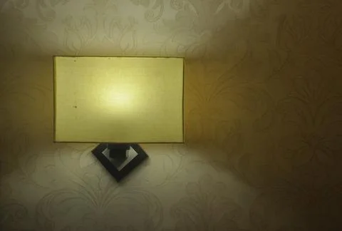 Front view of square shaped wall light lamp with textured wall Stock Photos