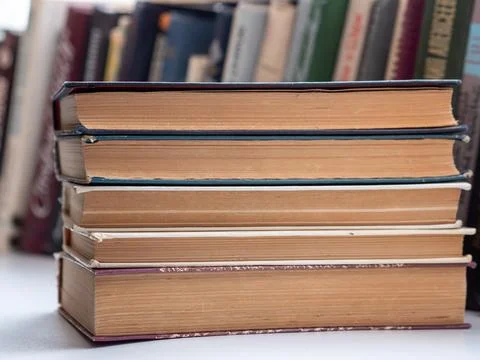 Front view stack of antique hardcover books on library table Stock Photos
