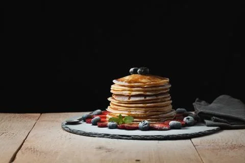 Front view of Stack of homemade plain pancakes with strawberries, blueberries Stock Photos