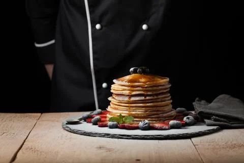 Front view of Stack of homemade plain pancakes with strawberries, blueberries Stock Photos