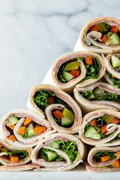 A front view of a stack piled high of freshly made wraps ready for eating. 스톡 사진