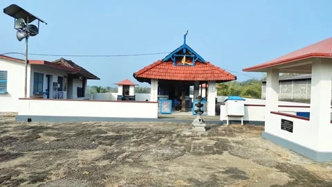 Front View Static Shot of Pamberian Para Murugan Temple: Stone Lamp on Rock.. Stock Footage 327214965