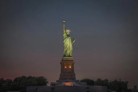 Front view of the statue of liberty at dusk Stock Photos