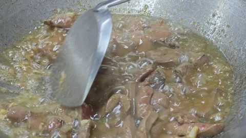 Front view of stir-frying sliced pork liver with a spatula. Stock Footage 342029003