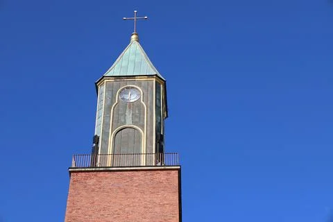 A front view of Stora kyrkan, a large red brick church with a prominent clock Stock Photos