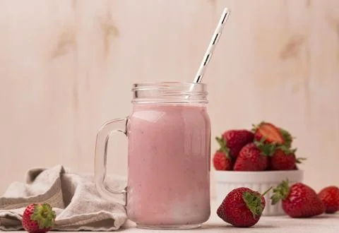 Front view strawberry milkshake with straw Stock Photos