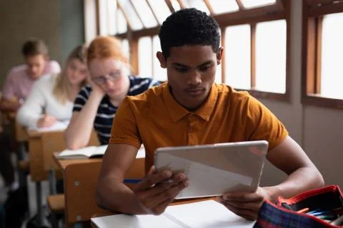 Front view of student using a touch pad in class 스톡 사진