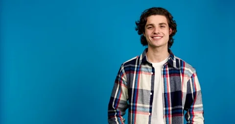 Front view of stylish man laughing and looking at camera isolated on blue Stock Footage 124535381