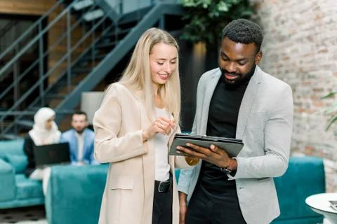 Front view of successful smiling young multiracial business people, Caucasian Stock Photos
