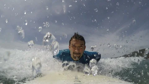 Front view of a surfer take off on a white surfboard Stock Footage 88775434