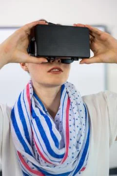 Front view of teacher using virtual reality headset in classroom 스톡 사진