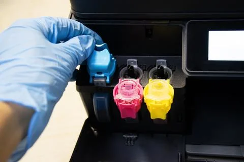 Front view of technician inspecting printer cartridges Stock Photos