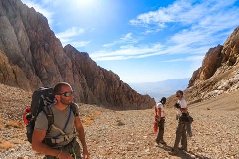 Front view of three mountain climbers at Aladaglar Mountain against blue sky Stock Photos