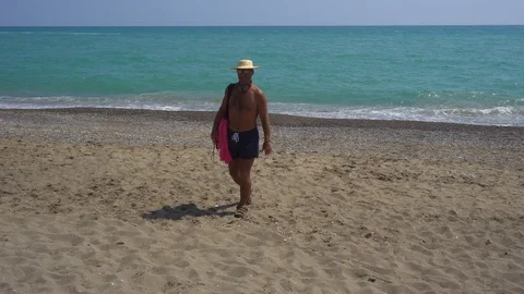 Front View Of A Traveling Man With A Backpack Enjoying  On The Beach Stock Footage 96704181