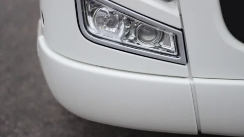 Front view of a truck headlight closeup in rainy weather, camera paning Stock Footage 69909461