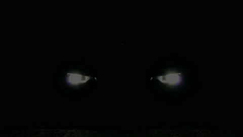 Front view of turning on the headlights in the car at night Stock Footage 136858578