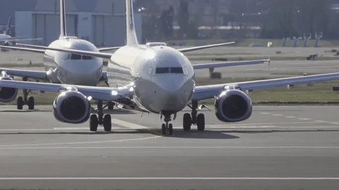 Front view of two airplanes waiting on the taxiway at the airport. Stock Footage 121688962