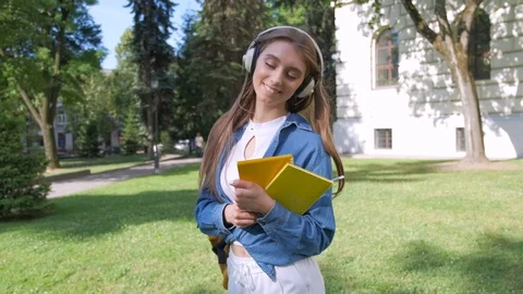 Front view of two beautiful students of African and European descent, standing Stock Footage 111956029
