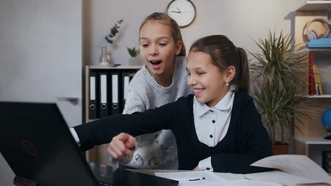 Front view of two happy smiling likable teen girls which using computer while Stock Footage 124698564