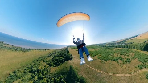 Front view of two people flying on the paraglider. Man Paragliding, beautiful Stock-Footage 117895935