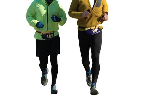 Front view of two runners moving during a 5K race on a cold winter day Stock Photos
