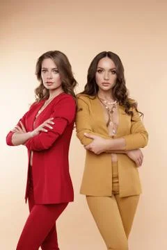 Front view of two sexy models with folded arms posing Stockfoto's