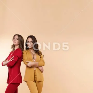 Front view of two sexy models with folded arms posing Stock Photos