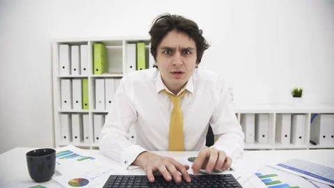 Front view of typing stressed man 스톡 동영상 74250146