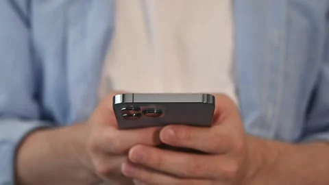 Front view on unrecognizable man with smartphone. Mobile games,testing,freelance Stock Footage 253680171