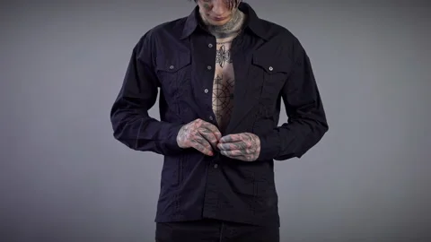 Front view unrecognizable young man with tattooed torso and hands buttoning 動画素材 163149830